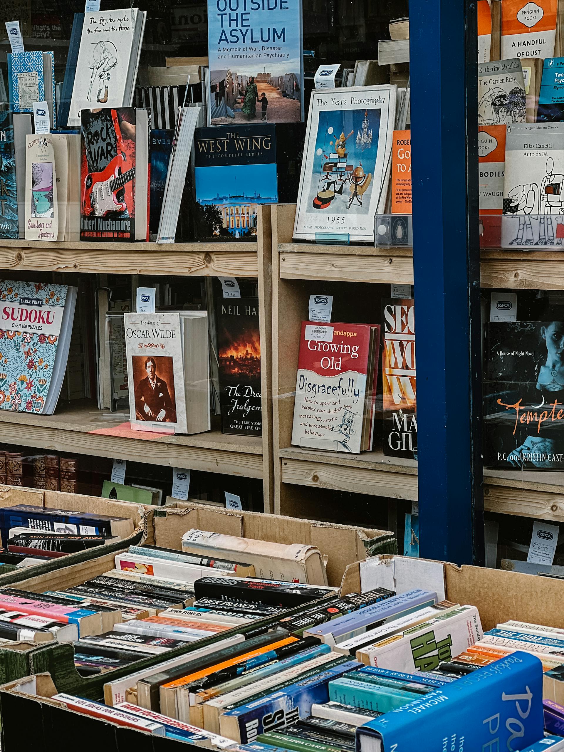 Explore a wide range of books neatly organized on shelves in a book store setting.
